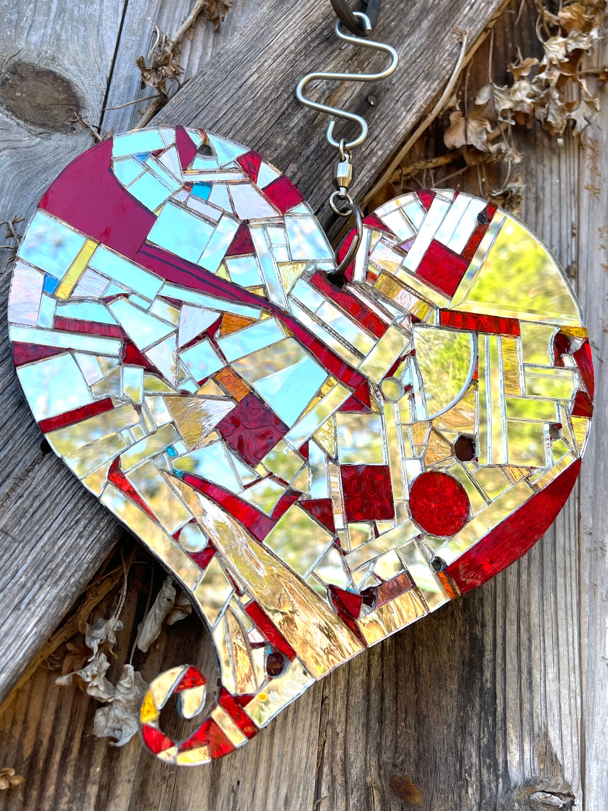 Beautiful mirror mosaic heart sun catcher. Red and silver on one side, blue and silver on the other.